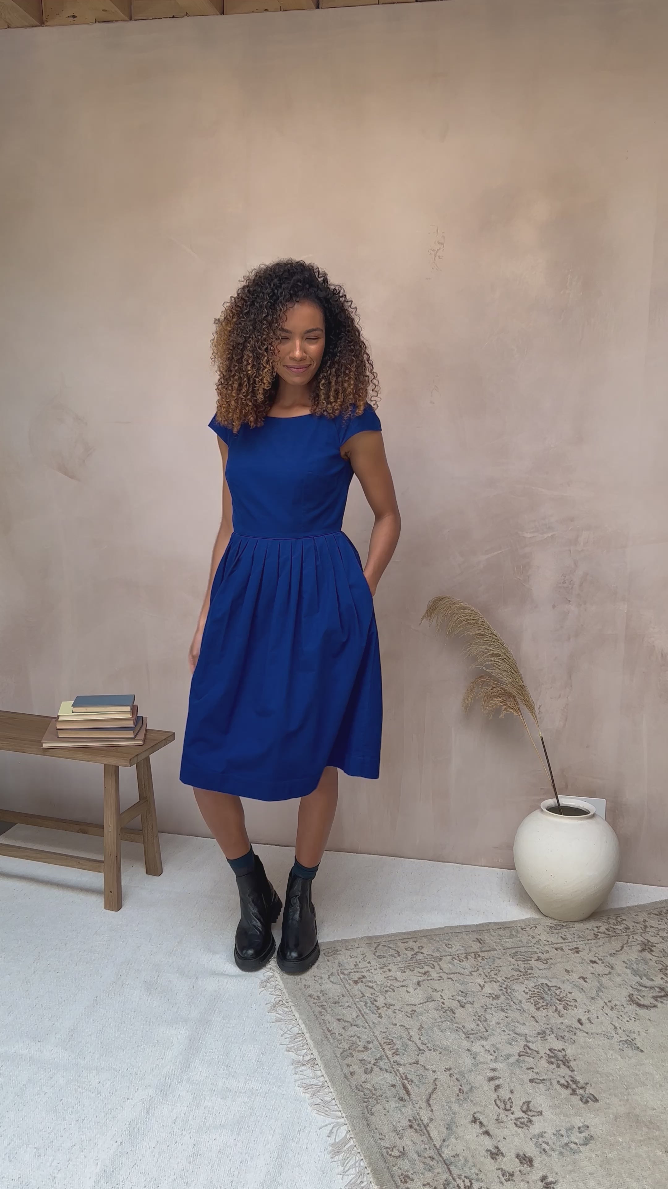 Image of the Claudia Dress in Cobalt Needlecord by Emily and Fin, presented in a video.